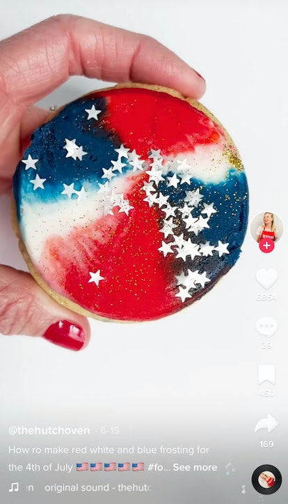 A woman shows off her Fourth of July recipes from TikTok of a frosted sugar cookie. 