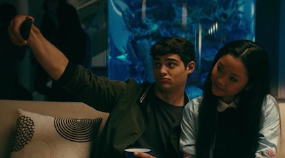 Lara Jean and Peter Kavinsky take a selfie, while sitting on a couch in 'To All The Boys I've Loved ...