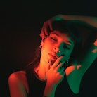 Portrait of young woman illuminated neon light on July 17, 2023, the most transformative day of the ...