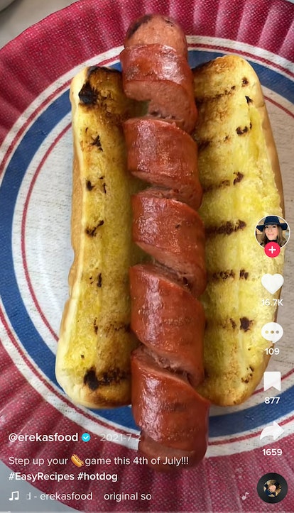 A woman shows off her Fourth of July recipes from TikTok of a spiral hot dog. 
