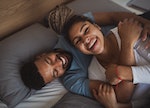 Man and woman resting in bedroom, having fun.